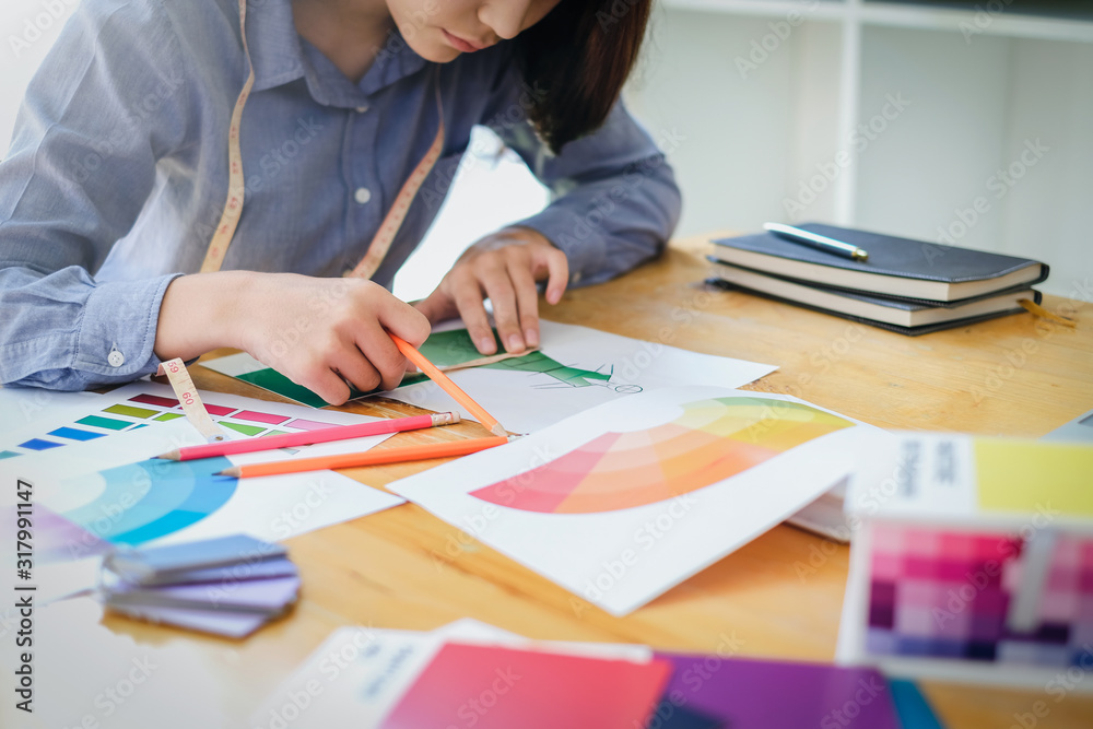 Young asian woman fashion designer is working in her workshop. Young asian woman fashion designer is working in her workshop.