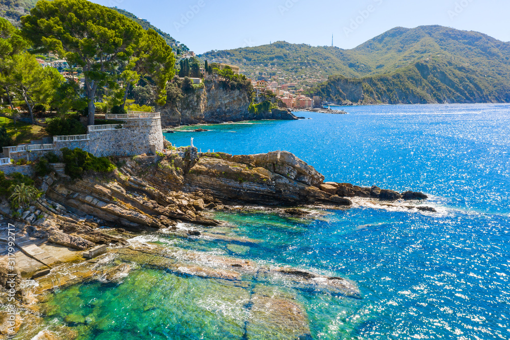 Fototapeta premium Rocky coast in Camogli, Italy. A bird-eye view on Adriatic seaside, Liguria.