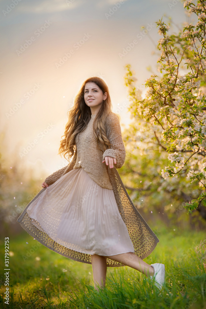 Long hair girl in blooming garden full length Long hair girl in blooming garden full length