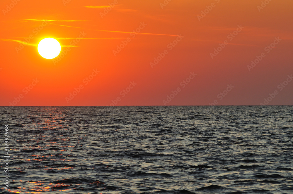 Beautiful colorful sunset over wavy waters of Black sea in Crimea