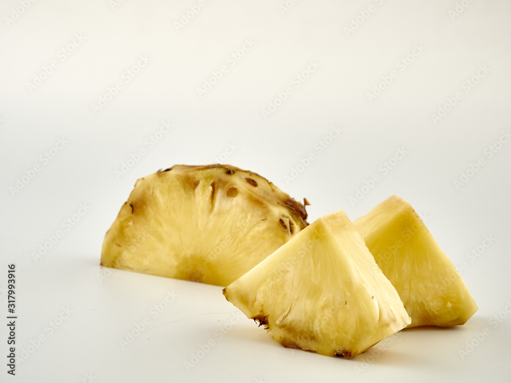 Delicious ripe Pineapple and its slices on a white background.Isolate Delicious ripe Pineapple and its slices on a white background.Isolate