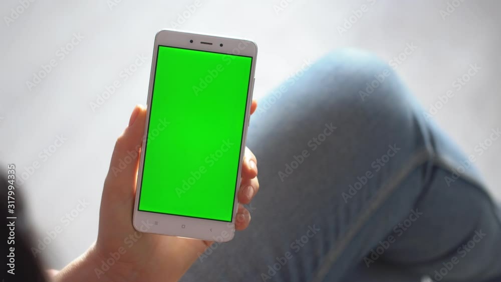 business woman using smartphone viewing green screen on mobile phone browsing chroma key online watching enjoying drinking coffee reading social media close up hands