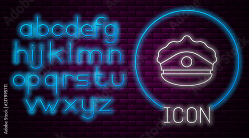Glowing neon line Police cap with cockade icon isolated on brick wall background. Police hat sign. Neon light alphabet. Vector Illustration