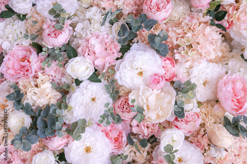 Background panel of artificial flowers peonies, roses and eucalyptus.