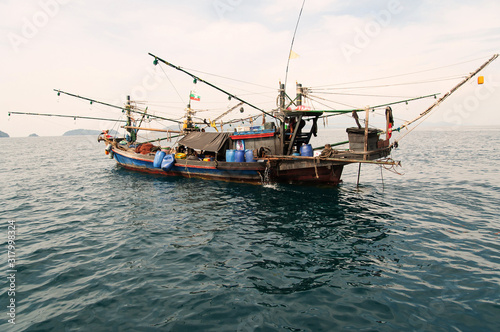 An old traditional fishing boat in Myanmar Sea. photo