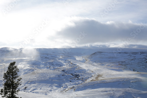 Blizzard or snowstorm in the mountains in winter. Winter landscape. Panoramic view of the mountains.