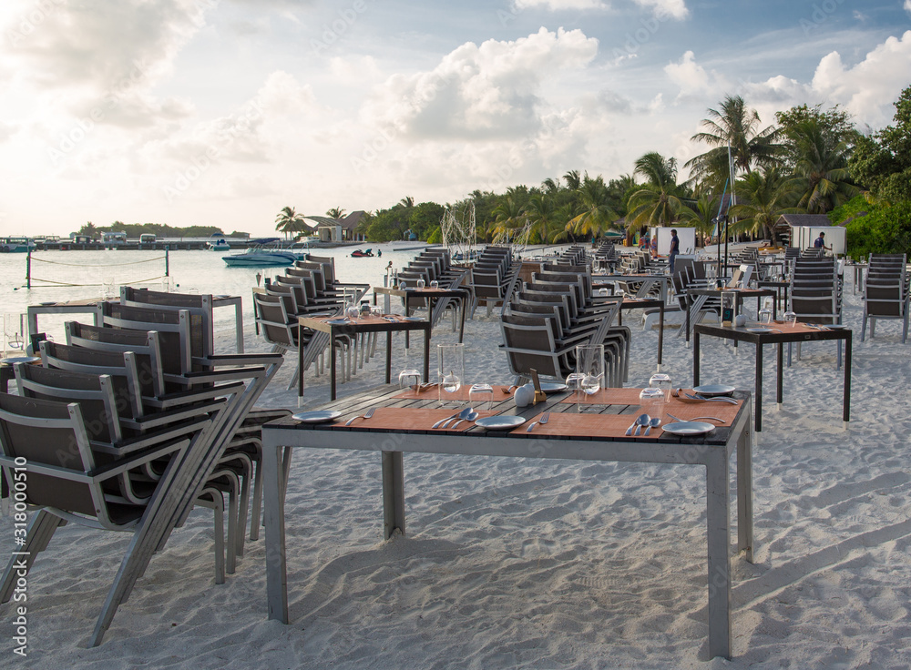 table setting on a resort beach at sunset table setting on a resort beach at sunset