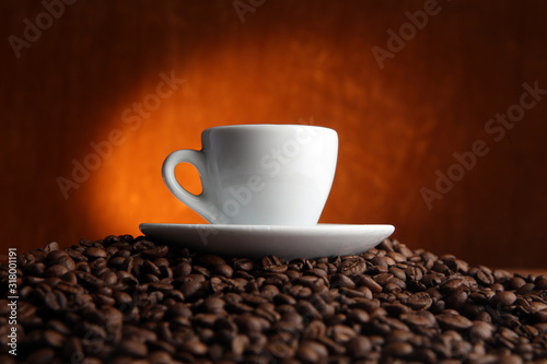 cup of coffee on coffee beans