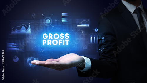 Hand of Businessman holding GROSS PROFIT inscription  business success concept
