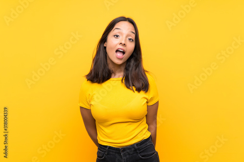 Young brunette girl over isolated background with surprise facial expression