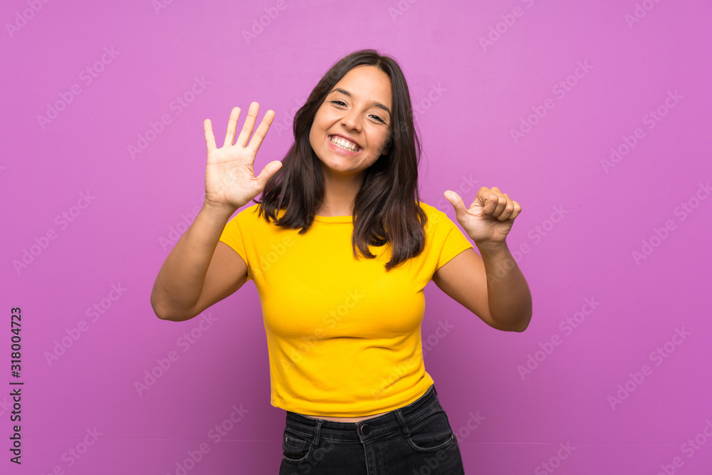 Young brunette girl over isolated background counting six with fingers Young brunette girl over isolated background counting six with fingers