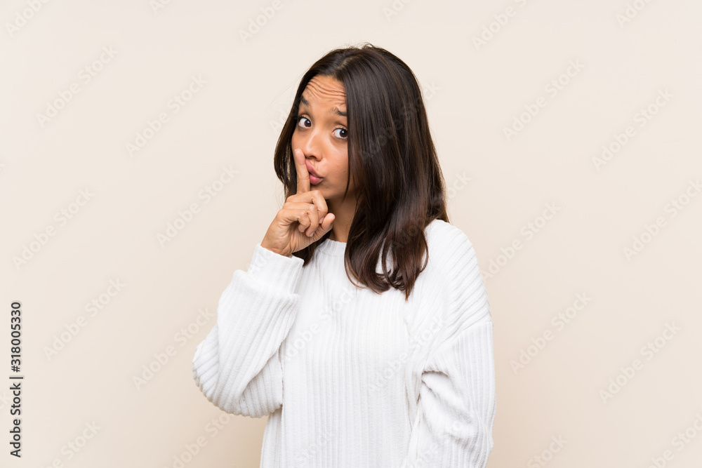 Fototapeta premium Young brunette woman with white sweater over isolated background doing silence gesture