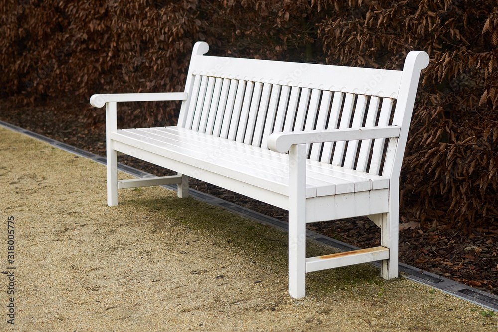 White wooden bench in the park.