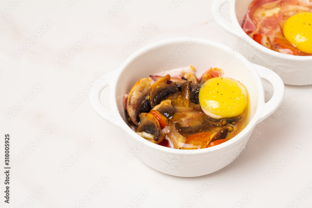 fried eggs with mushrooms and tomatoes, bacon on a white background fried eggs with mushrooms and tomatoes, bacon on a white background