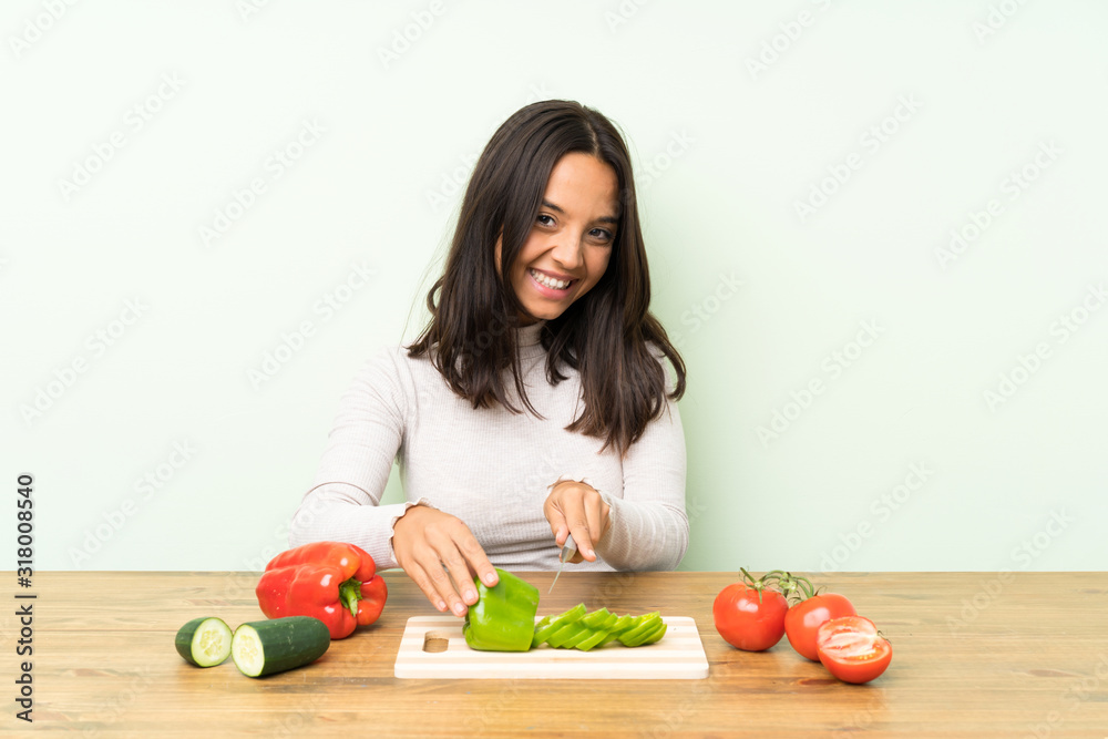 Young brunette woman with lots of vegetables