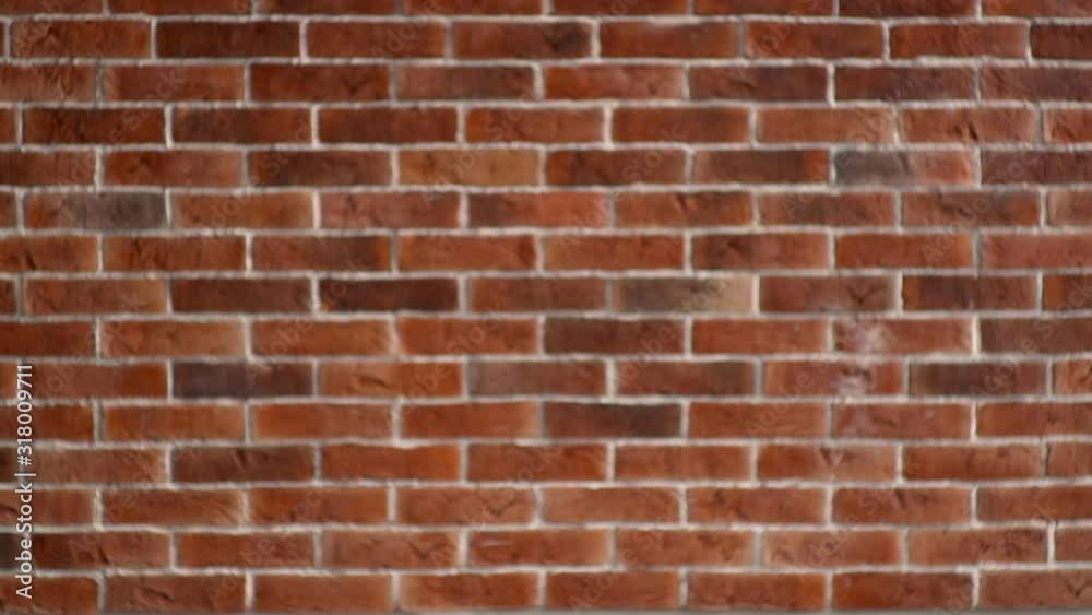 An office worker with a cardboard box walks into the frame against a brick wall, shrugs and leaves. Dismissed Arab man with personal belongings An office worker with a cardboard box walks into the frame against a brick wall, shrugs and leaves. Dismissed Arab man with personal belongings