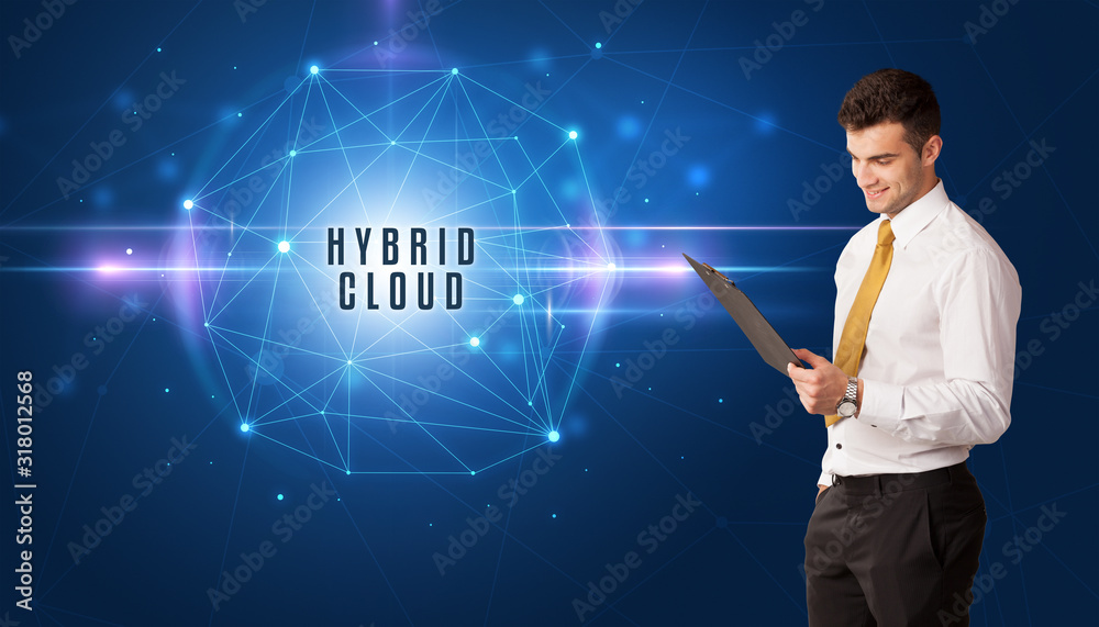 Businessman thinking about security solutions with HYBRID CLOUD inscription Businessman thinking about security solutions with HYBRID CLOUD inscription