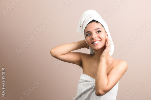 a beautiful brunette with blue eyes wrapped in the bath towel. Skincare illustration. SPA advertising