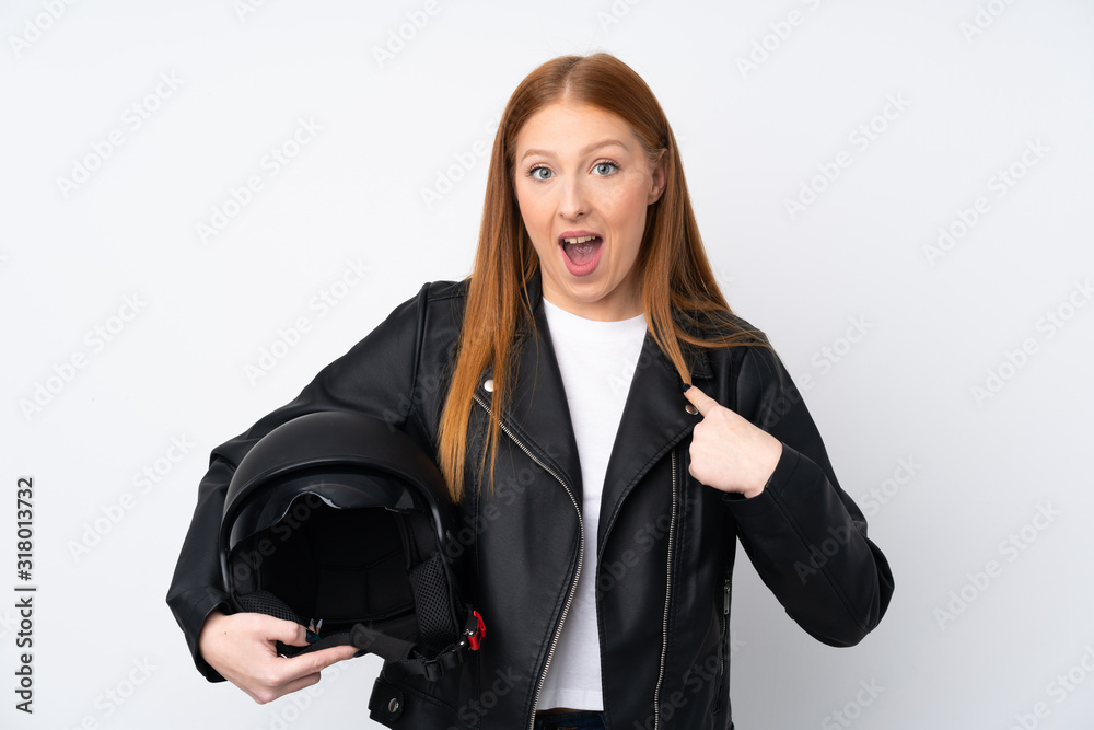 Young redhead woman with a motorcycle helmet over isolated white background with surprise facial expression