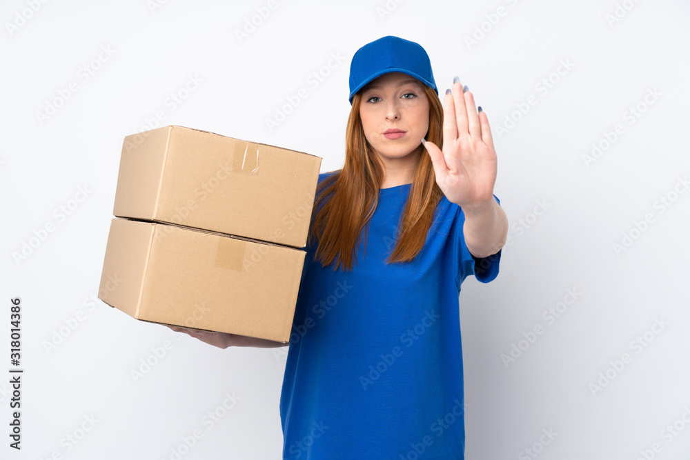 Young delivery woman over isolated white background making stop gesture with her hand Young delivery woman over isolated white background making stop gesture with her hand