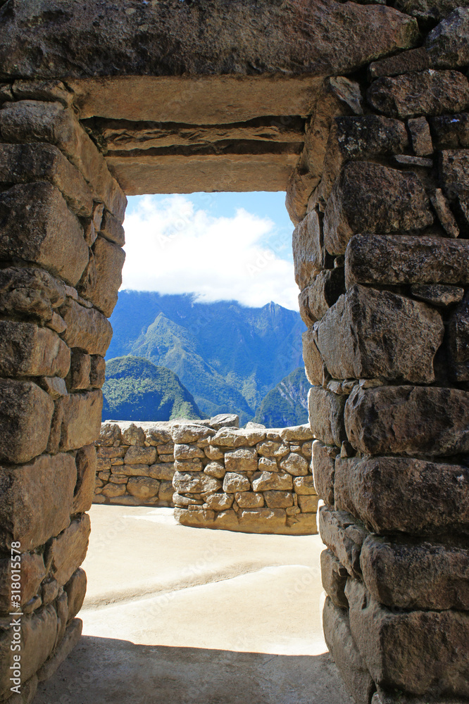 View of the Andes Mountains through a doorway at Machu Picchu