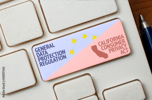 GDPR and CCPA concept: a white keyboard with a key with text general data protection regulation and california consumer privacy act. This two laws regulate data protection and privacy. photo