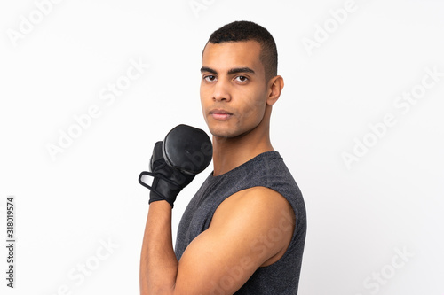 Young African American sport man over isolated white background making weightlifting © luismolinero