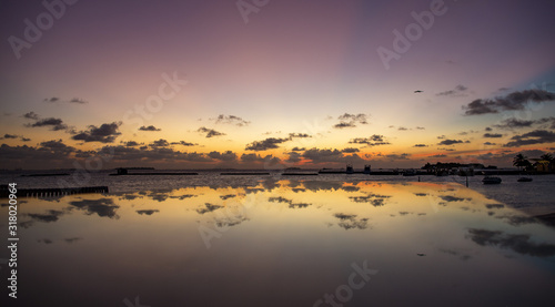 reflection of a table on a resort beach at sunset