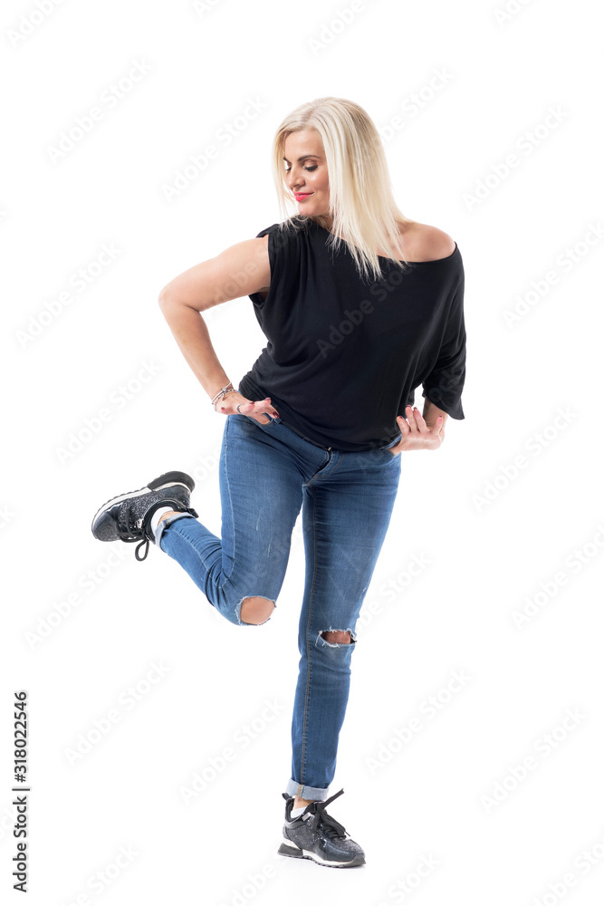 Vitality balance concept. Healthy playful middle age woman in fifties with casual clothes standing on one leg. Full body isolated on white background. Vitality balance concept. Healthy playful middle age woman in fifties with casual clothes standing on one leg. Full body isolated on white background.