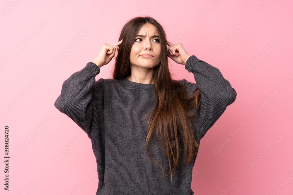 The young woman is looking sad on the pink background. Stock Photo by  ©vova130555@gmail.com 186125244