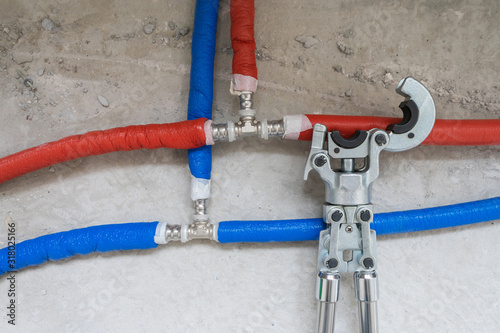 Plumbing copper pipe crimper press tube tool. Heating pipes connected by press fittings. Hydraulic, tools for plumber.