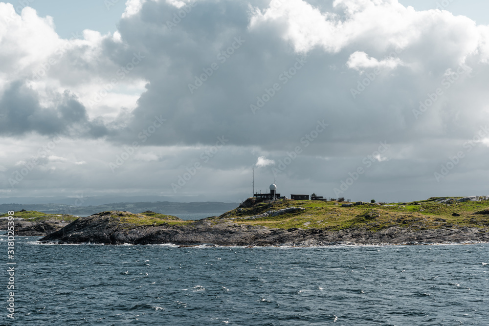Harsh sea at Mortavika and the weather or radar station on the small hill, Norway