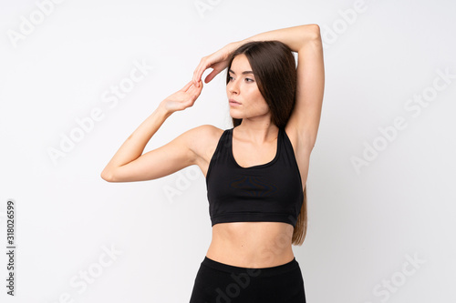 Young sport woman over isolated white background stretching