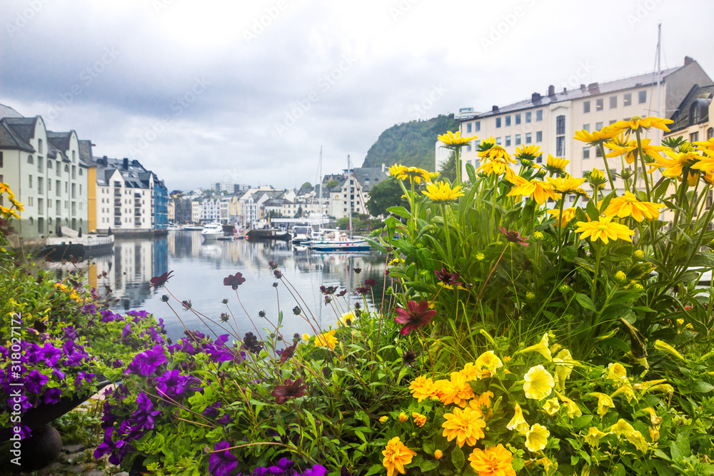 clouds over the harbor and the waterfront buildings in Alesund