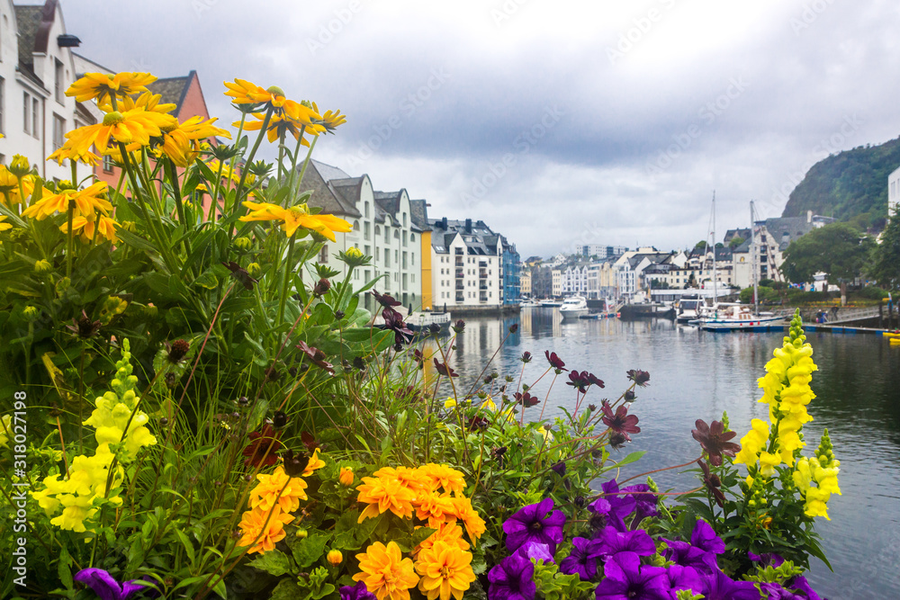 clouds over the harbor and the waterfront buildings in Alesund