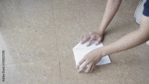 Young child making an airplane paper on the ground close up - Childhood game memory conept