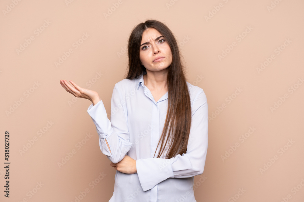 Young woman over isolated background unhappy for not understand something Young woman over isolated background unhappy for not understand something