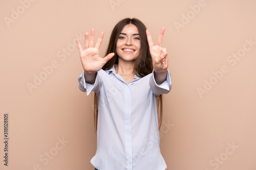 Young woman over isolated background counting seven with fingers © luismolinero