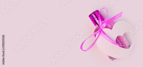 Valentines Day creative concept flat lay. Gift mockup, purple perfume bottle, ribbon heart card tag on white background. Top view copy space.8 march female present, web site header, advertising banner