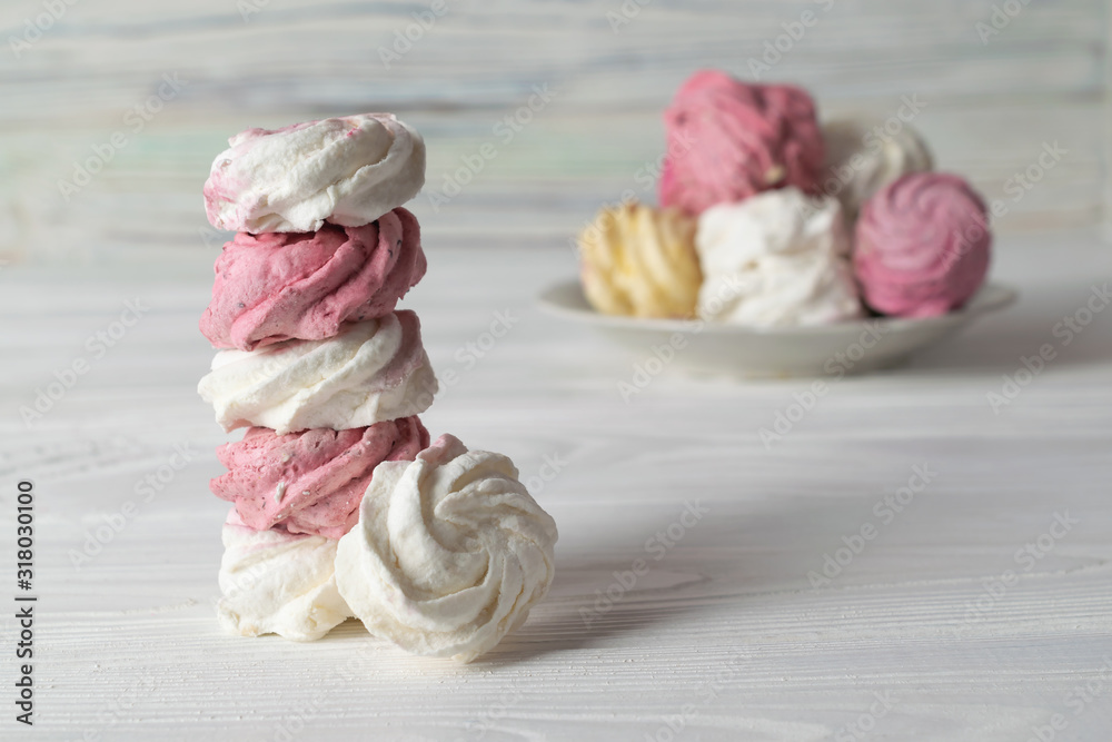 Stack of delicious homemade colorful marshmallows of different flavors on white wooden table Stack of delicious homemade colorful marshmallows of different flavors on white wooden table