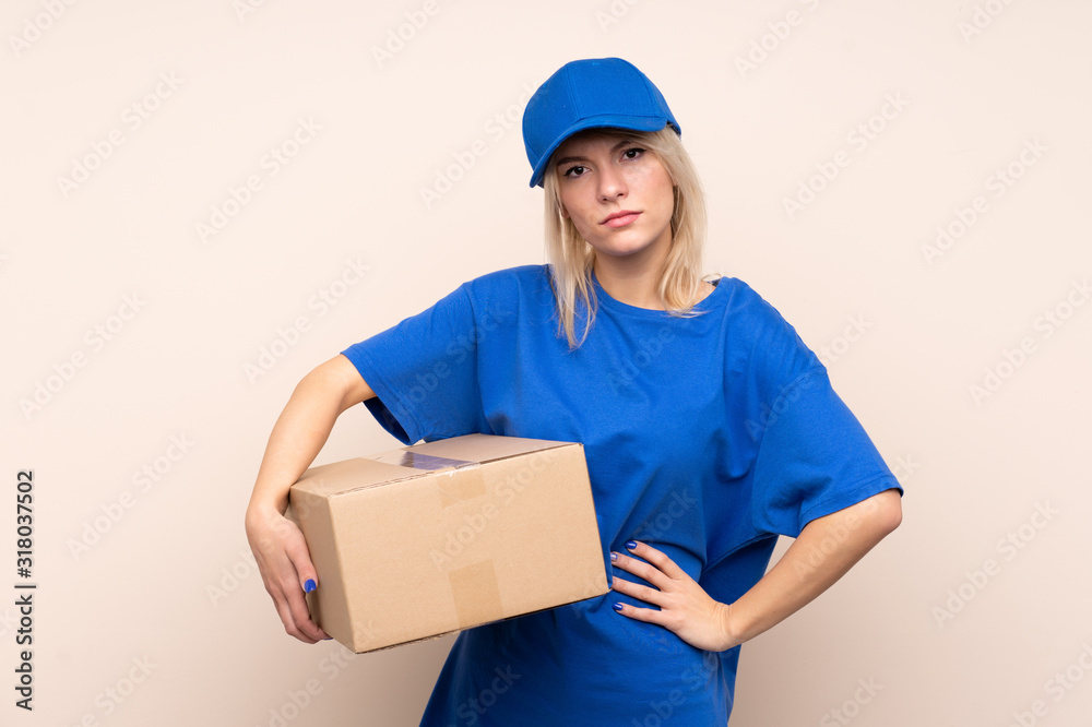 Young delivery woman over isolated background keeping arms crossed Young delivery woman over isolated background keeping arms crossed