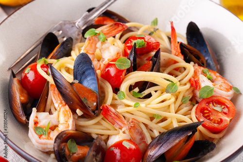 Seafood pasta. Spaghetti with mussels and tiger prawns, traditional pasta with shrimps close-up