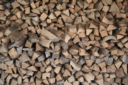 wall-mounted firewood, background of dry chopped wood, logs in a pile. Concept.