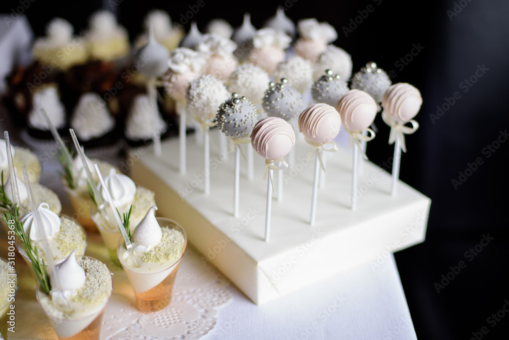 White decorated cake pops on the candy bar