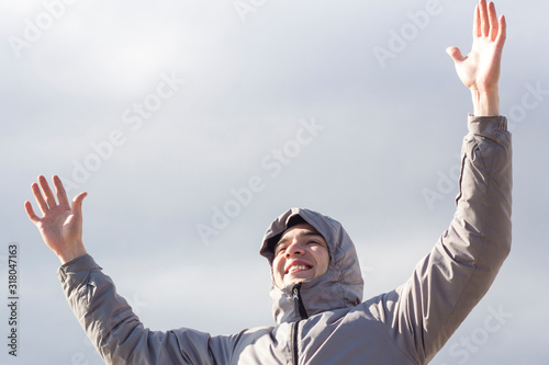 happy young man with her arms outstretched