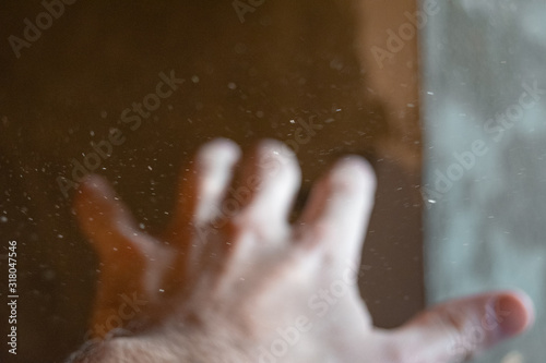 hand with glass of water on black background