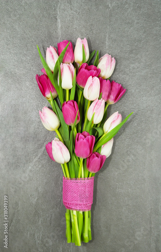 Bouquet of tulips on grey background.