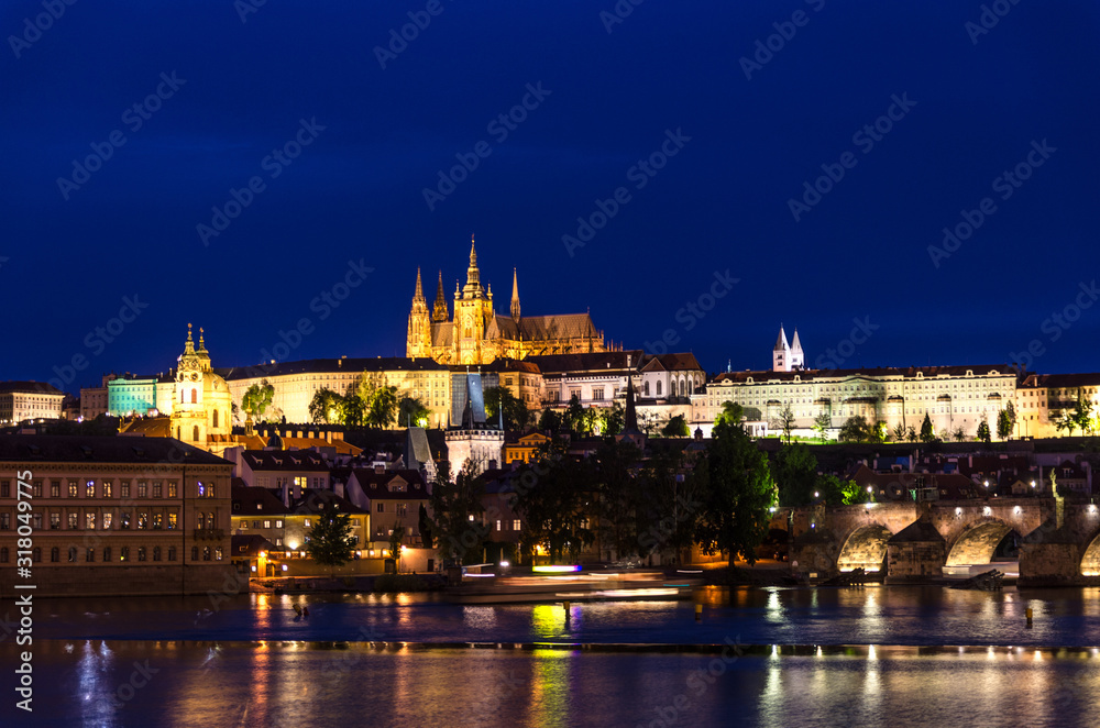 View of Prague old town, historical center with Prague Castle, St. Vitus Cathedral in Hradcany district, Charles Bridge Karluv Most, Vltava river, night twilight evening view, Bohemia, Czech Republic