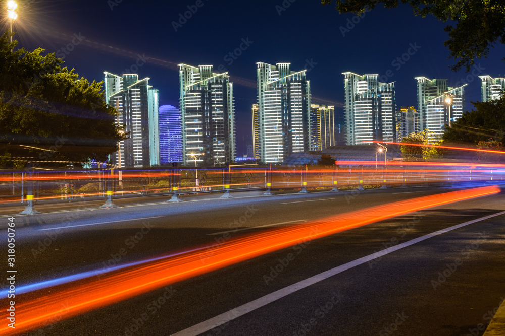 Night view of Sanya city with bright multi-colored illumination buildings, structures, roads, sidewalks, poles, bridges. Night view of Sanya city with bright multi-colored illumination buildings, structures, roads, sidewalks, poles, bridges.