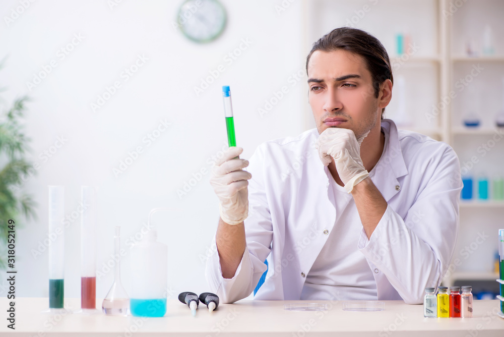 Young male chemist working in the lab Young male chemist working in the lab